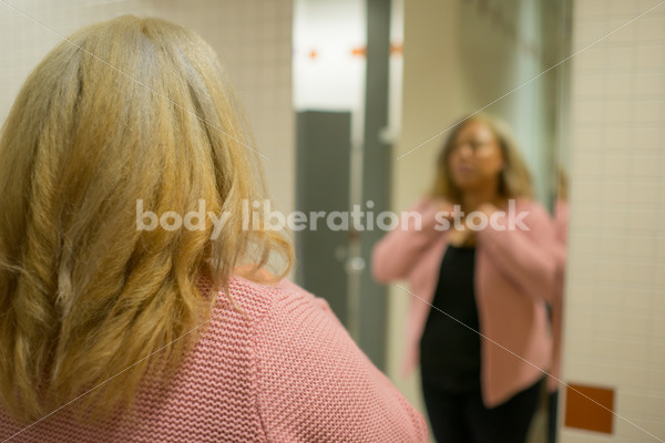 Body Image Stock Photo: Plus Size Woman in Office Bathroom Mirror - Body Liberation Photos