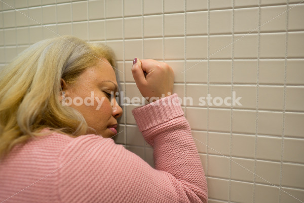 Mental Health and Illness Stock Image: Depressed Plus Size Woman in Office Building Bathroom - Body Liberation Photos