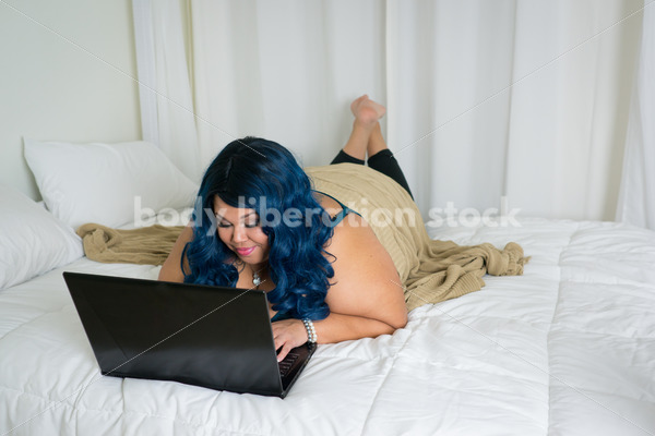 Royalty Free Stock Photo: Plus Size African American Woman Uses Laptop Computer on Bed - Body Liberation Photos