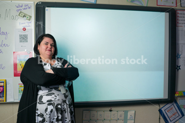 Royalty Free Stock Photo: Plus Size Teacher Writing on Smartboard - Body Liberation Photos