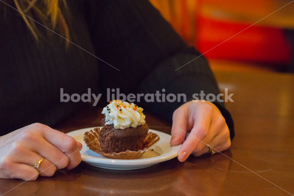 Royalty Free Stock Photo: Plus Size Woman with Cupcake in Coffee Shop - Body Liberation Photos