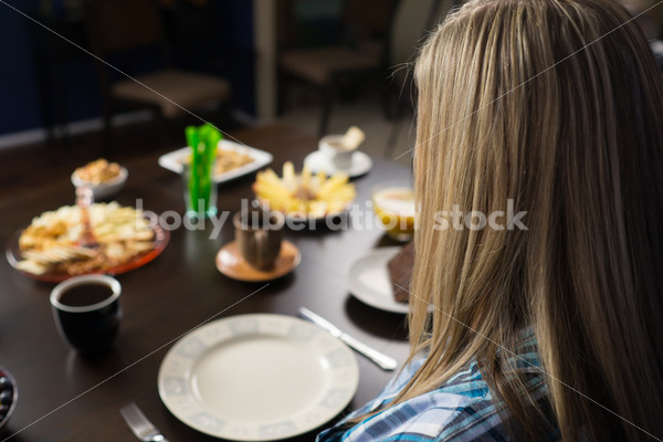 Royalty Free Stock Photo for Intuitive Eating: Plus Size Woman Considers Variety of Foods on Dining Table - Body Liberation Photos