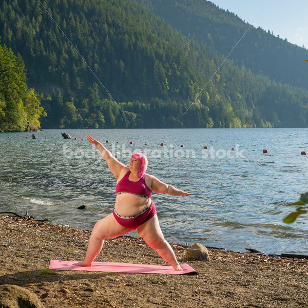 Stock Photo: Plus Size Woman Practices Yoga on Mountain Lake Shore