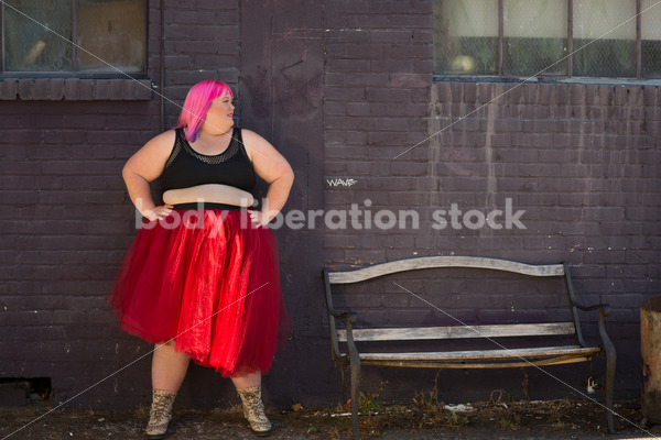 Stock Photo: Plus Size Woman with Pink Hair Standing with Purple Brick Wall - Body Liberation Photos