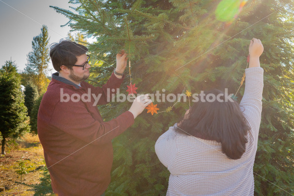 Holiday Stock Image: Plus-Size Couple at a Tree Farm - Body Liberation Photos