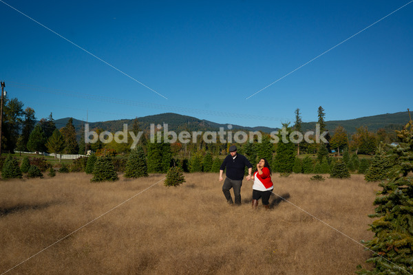 Joyful Movement Stock Image: Couple Running in Field - Body Liberation Photos