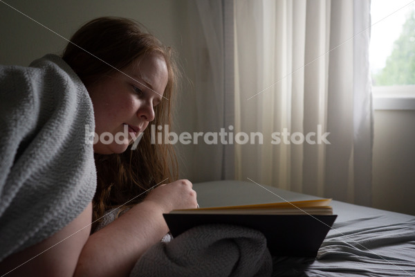 Self Care Stock Photo: Plus-Size Woman Reading in Bed - Body Liberation Photos