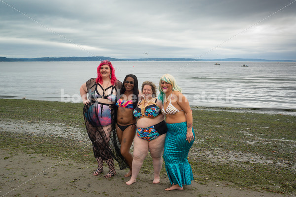 Stock Image: Group of friends walking on beach - Body Liberation Photos & Stock