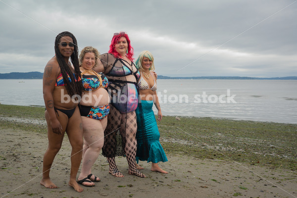 Stock Image: Group of friends walking on beach - Body Liberation Photos & Stock