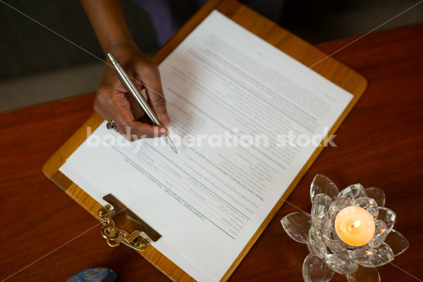 Small Business Stock Photo: Patient Signs Intake Forms