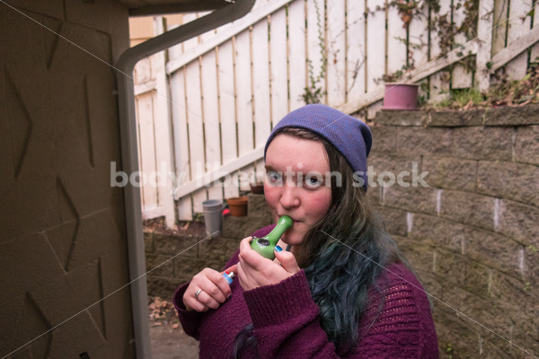 A young caucasian woman smokes legal marijuana in Washington state