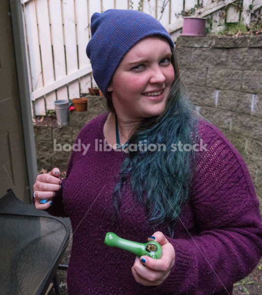 A young caucasian woman smokes legal marijuana in Washington state