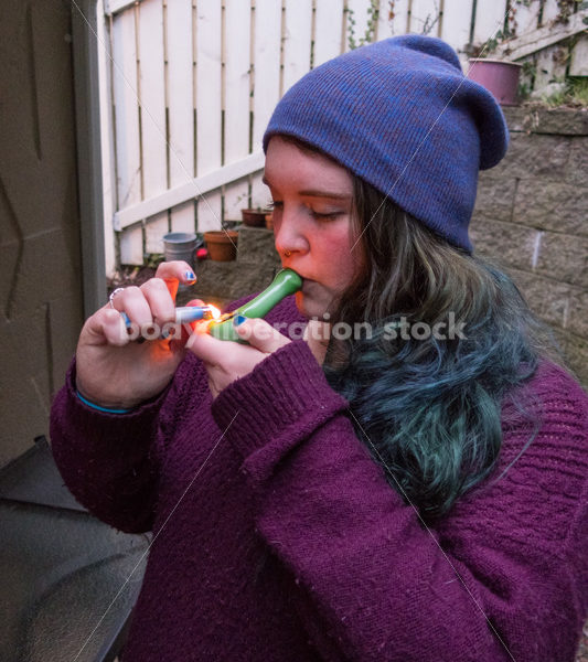 A young caucasian woman smokes legal marijuana in Washington state