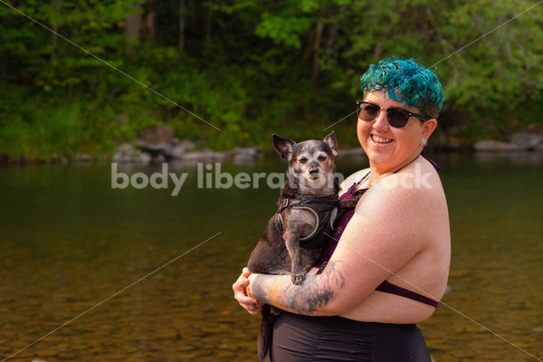 Summer Stock Photo: Non-Binary Person in River with Dog
