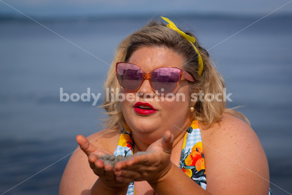 Body-Positive Stock Photo: Plus Size Woman Holds Sand in Front of the Ocean - Body Liberation Photos & Stock